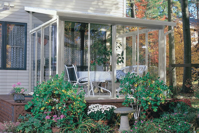 Sunroom that is turned into a greenhouse and has plants inside