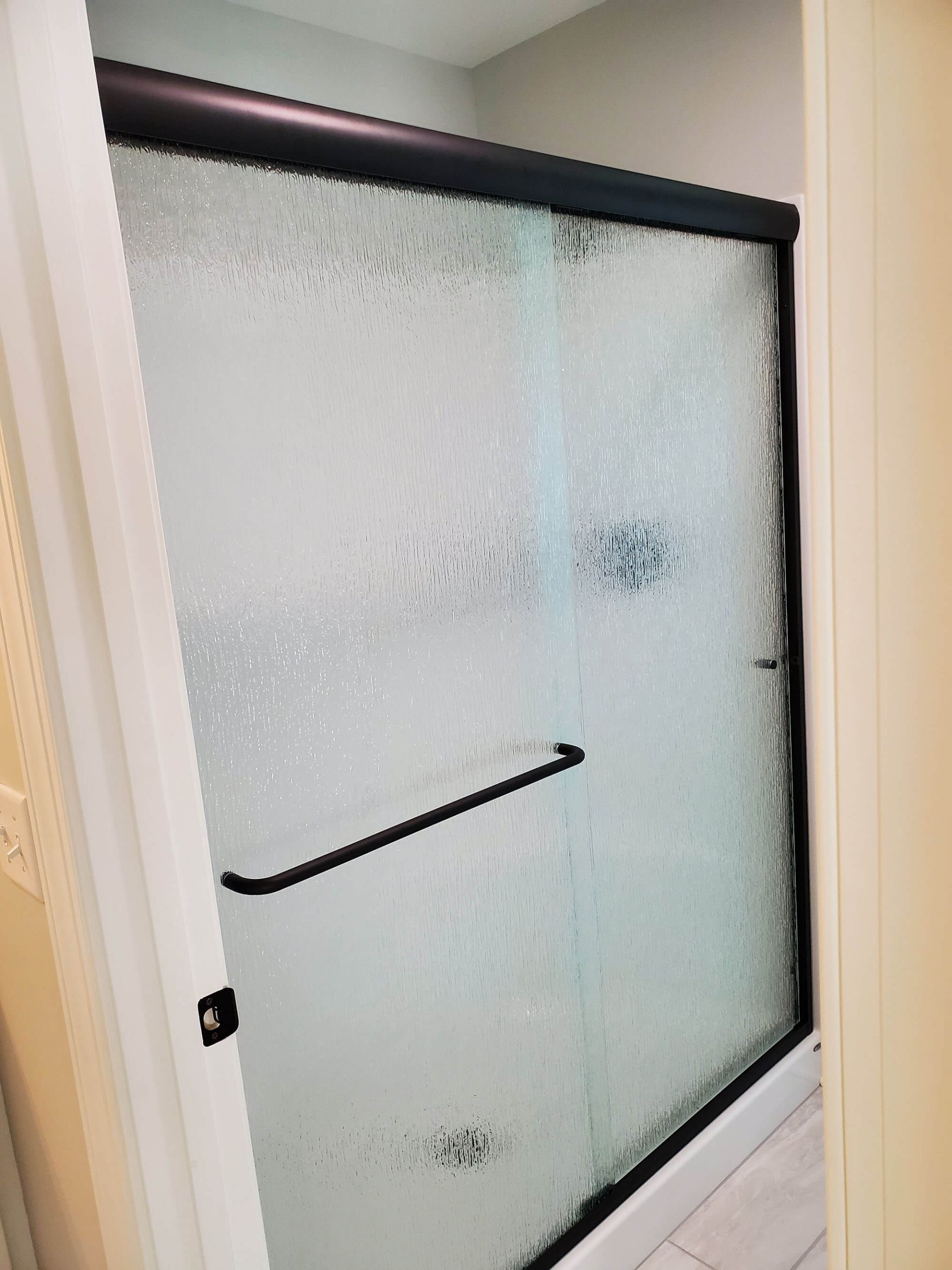 Shower with a framed glass door